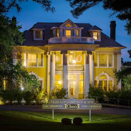 Claramount Inn at night with landscape lighting